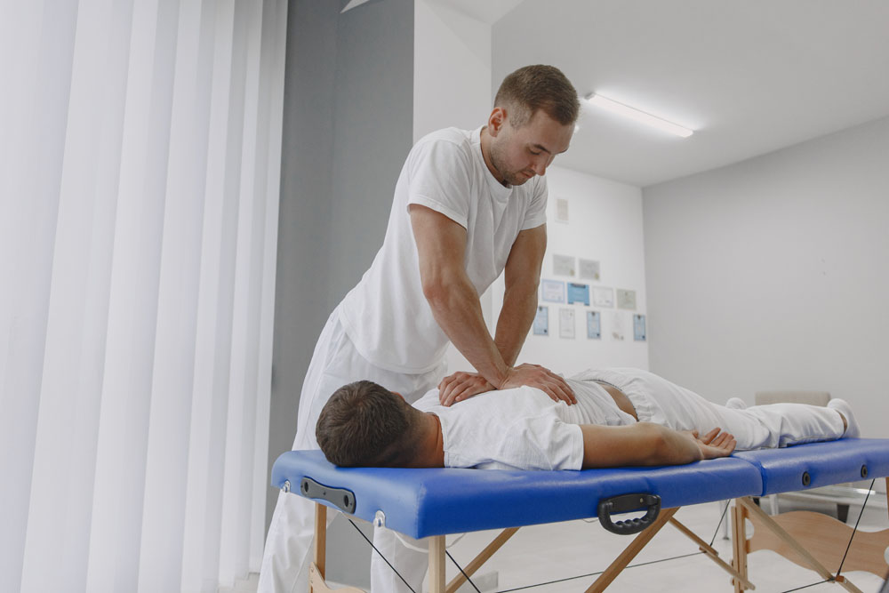 Back Cracking Male physiotherapist massaging man's back